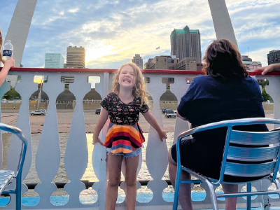 Girl with a big smile on the top deck of the Riverboat.