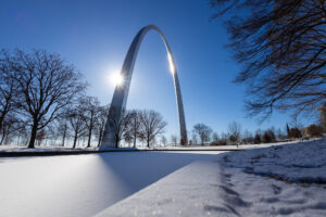 View of one of the reflection ponds at Gateway Arch National Park covered in snow