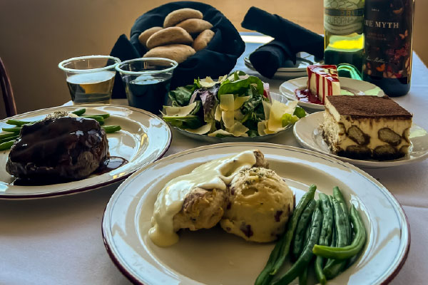 A full table plated before a Skyline Dinner Cruise