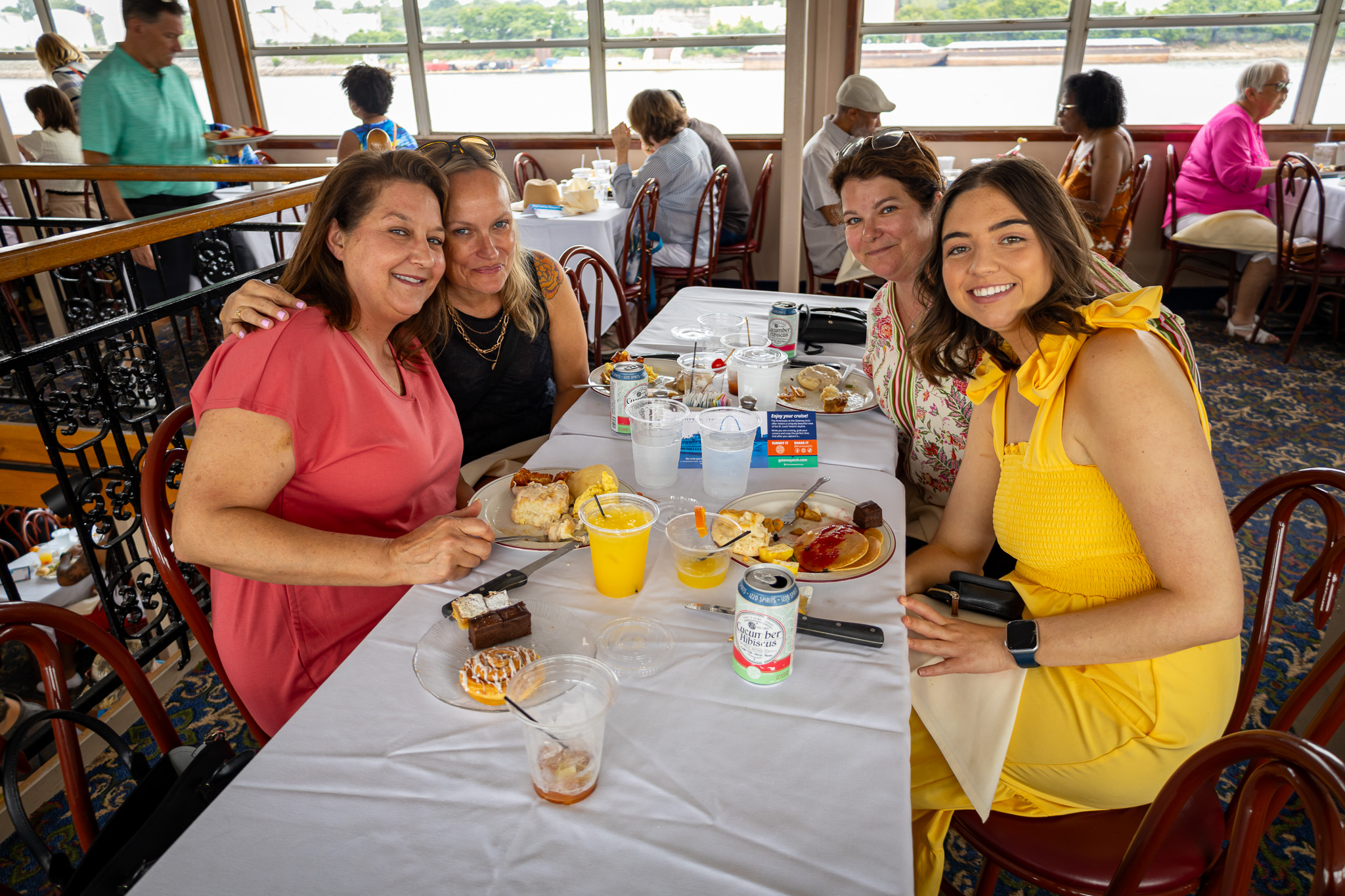 A group of four women eating on a Brunch Cruise aboard the Riverboats at the Gateway Arch.